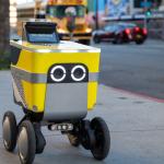 Food delivery robot on city sidewalk.