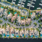 Aerial view of waterfront large single family homes with swimming pools