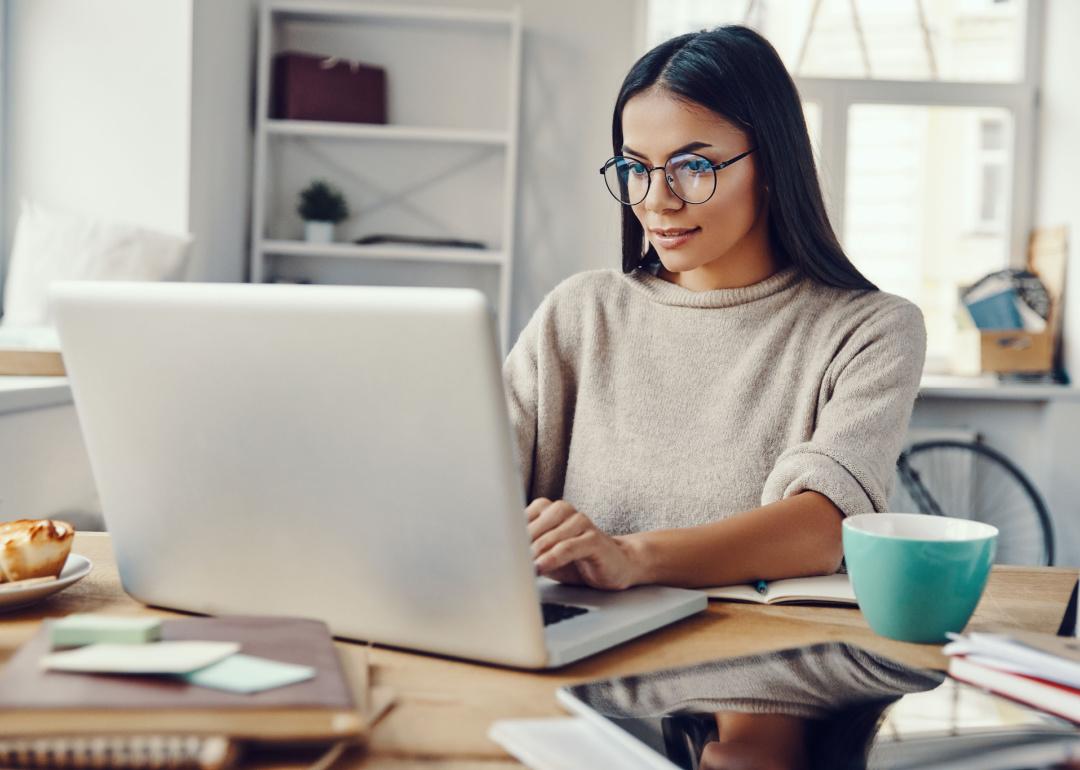 Person working on laptop computer in their home.