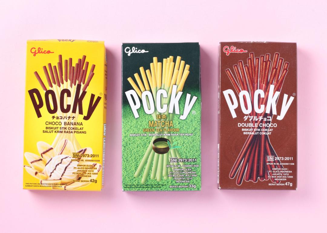 Three Pocky boxes on pink background.