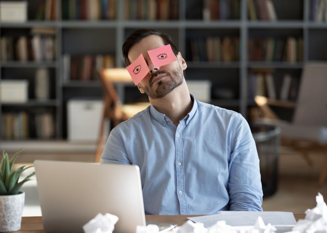Worker with sticky notes covering eyes.