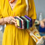 Cropped view of teacher collecting phones in classroom.