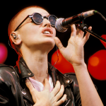 Sinead O’Connor performing onstage.
