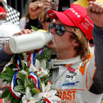 Dan Wheldon drinks milk in the victory lane.