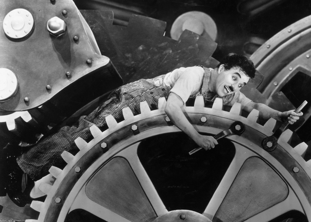 Charles Chaplin on large set of gears in a still from 'Modern Times'.