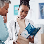 Older Black patient discussing health care with doctor.