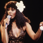 Donna Summer performs in halter dress with flower in her hair