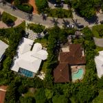 Aerial overhead shot of luxury homes with palm trees