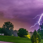 Lightning strikes in purple sky in green area of US