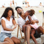Family enjoys a laugh on the beach