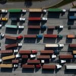 Trucks transport cargo containers at the Port of Baltimore in Baltimore, Maryland, on Oct. 14, 2021.
