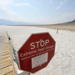  Stop sign warns of extreme heat danger at the salt flats of Badwater Basin inside Death Valley National Park.