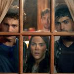 Three people look out a window scared in Eli Roth's "Cabin Fever."