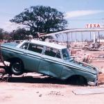 Damaged car in front of a Texaco after Hurricane Camille in 1969.