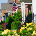 Houses with American flags and picturesque landscaping in America.