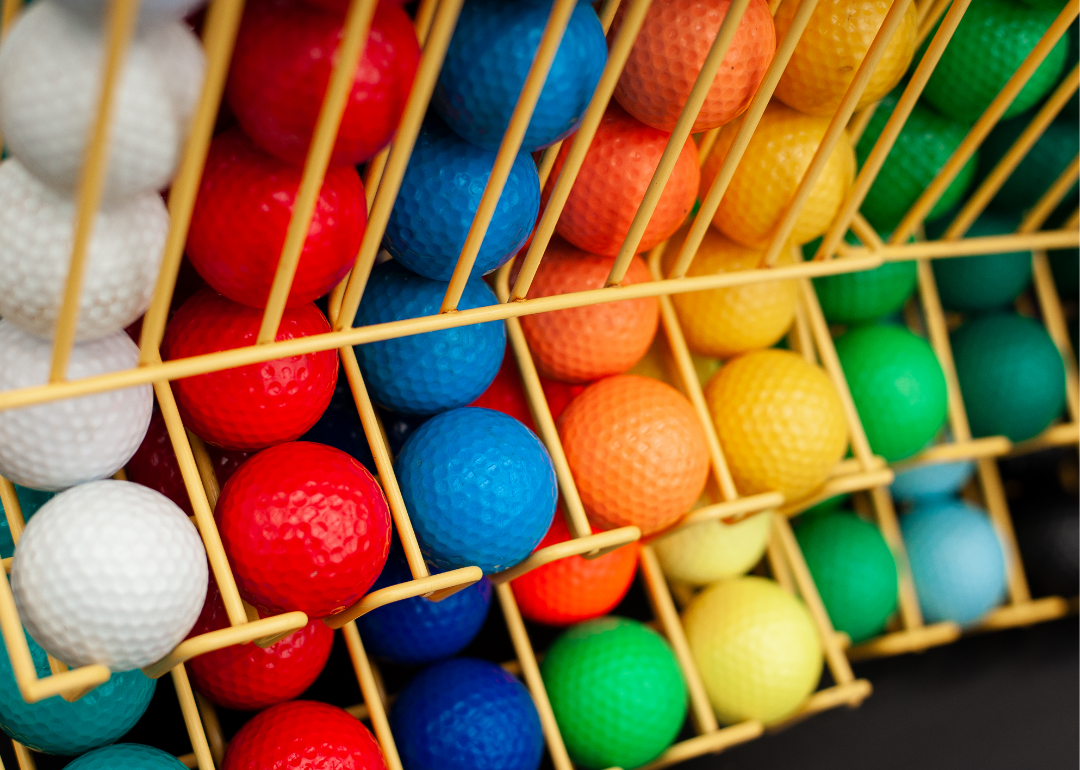 White, red, blue, orange, yellow, and green minigolf balls.