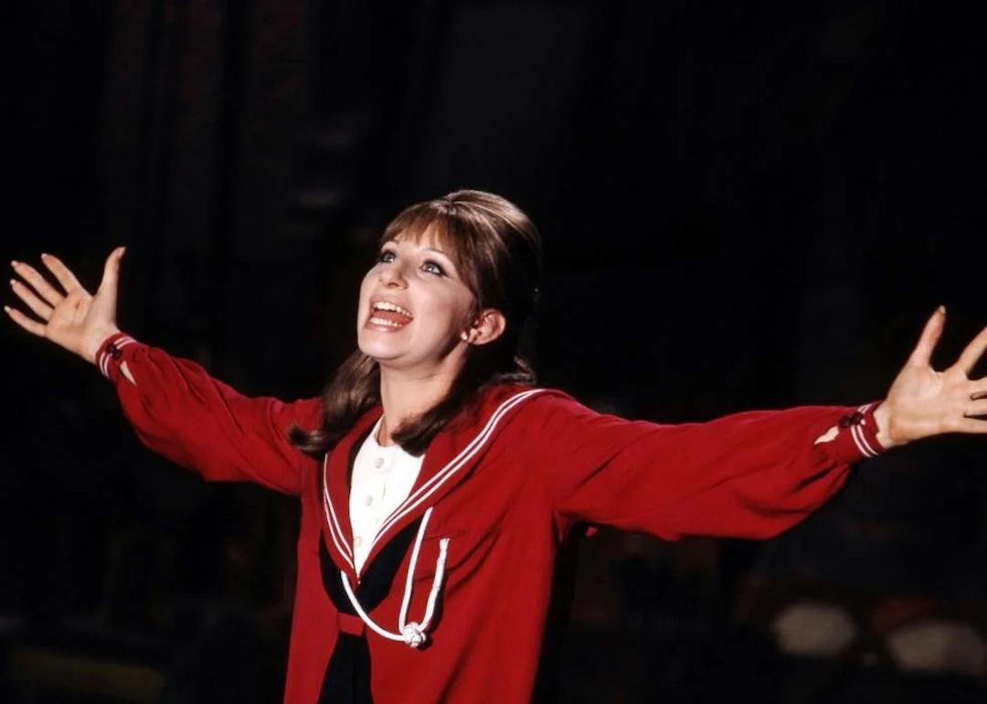 Barbra Streisand in a red dress singing "Don't Rain on My Parade" in "Funny Girl"