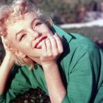 Marilyn Monroe poses for a portrait laying on the grass in 1954 in Palm Springs, California. 