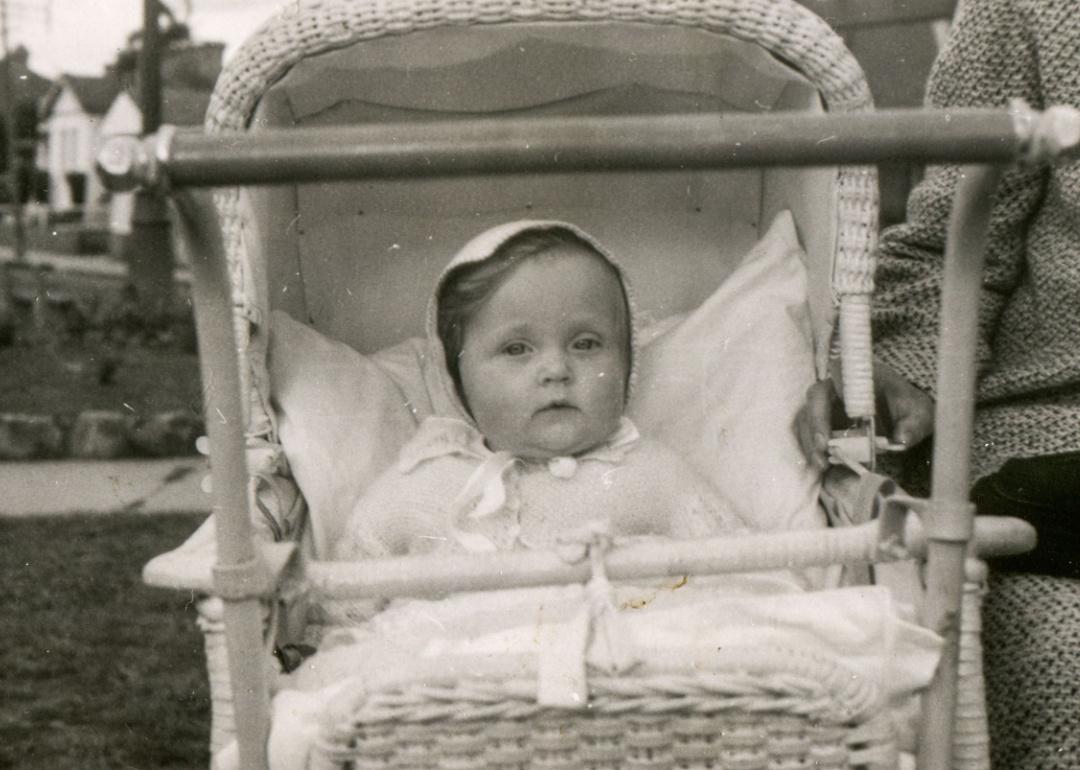 Vintage photo of baby girl in a stroller
