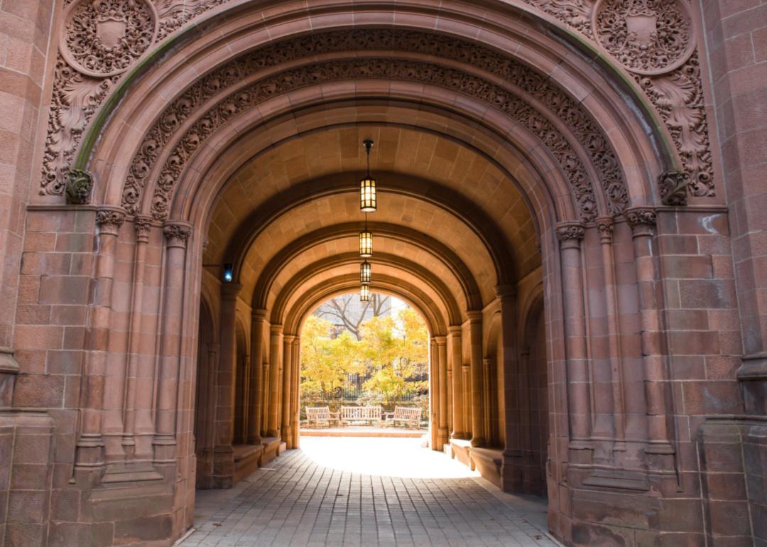 View of Yale University at the arched gate at Vanderbilt Hall on an autumn day.