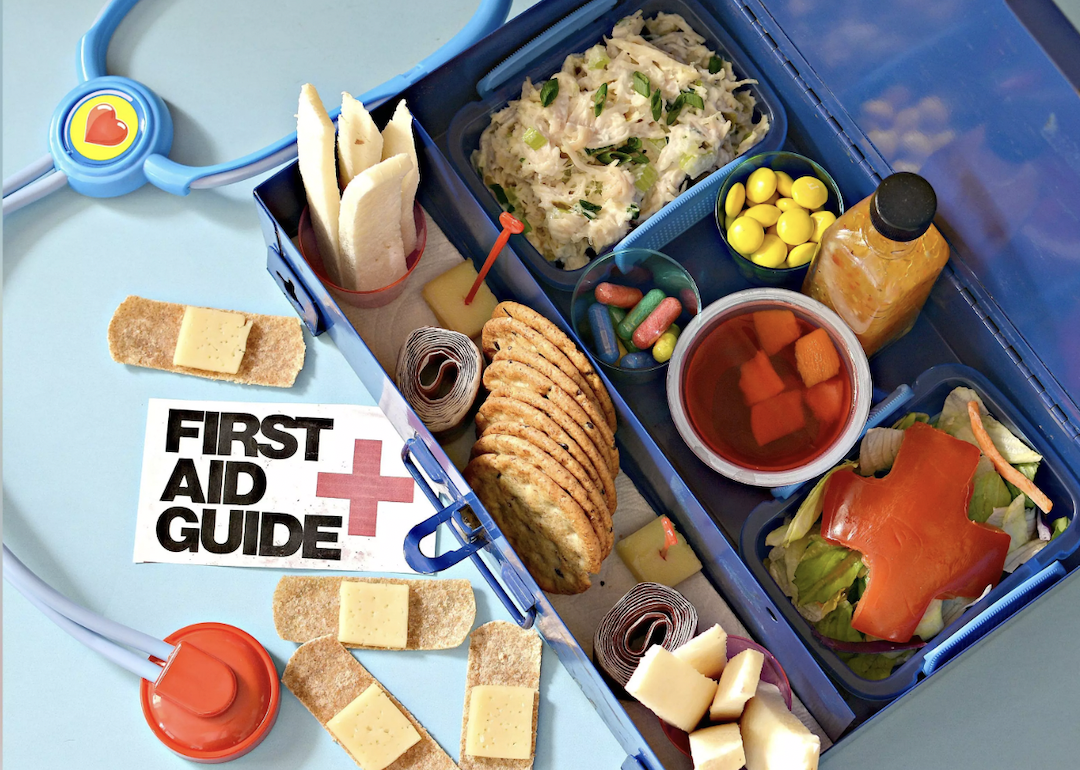 Lunch box filled with first aid-themed food and snacks