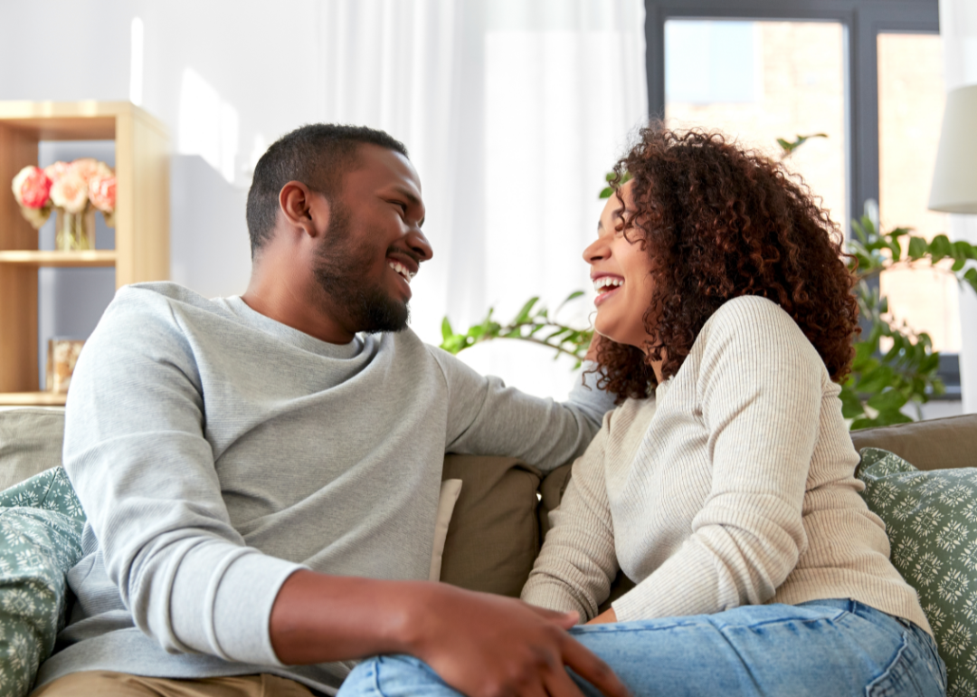 Happy couple at home on their couch