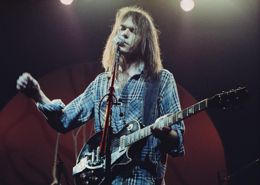 Canadian singer-songwriter and musician Neil Young performs on stage with Crazy Horse at Hammersmith Odeon, London, in 1976.