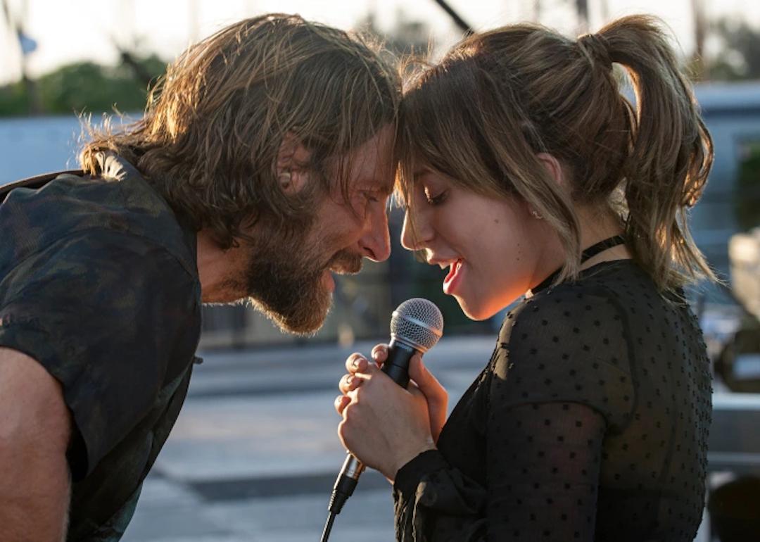 Bradley Cooper and Lady Gaga sing to each other as their heads touch in 'A Star Is Born.'