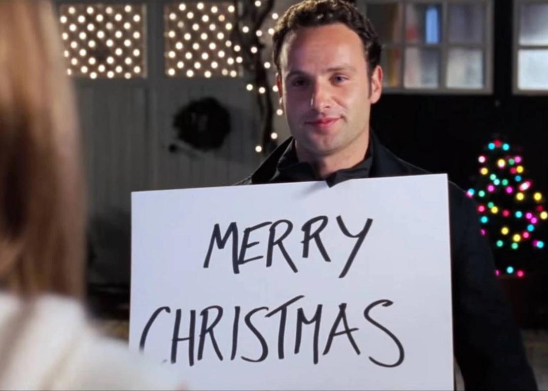 Andrew Lincoln holding a sign that says 'Merry Christmas' in 'Love Actually.'