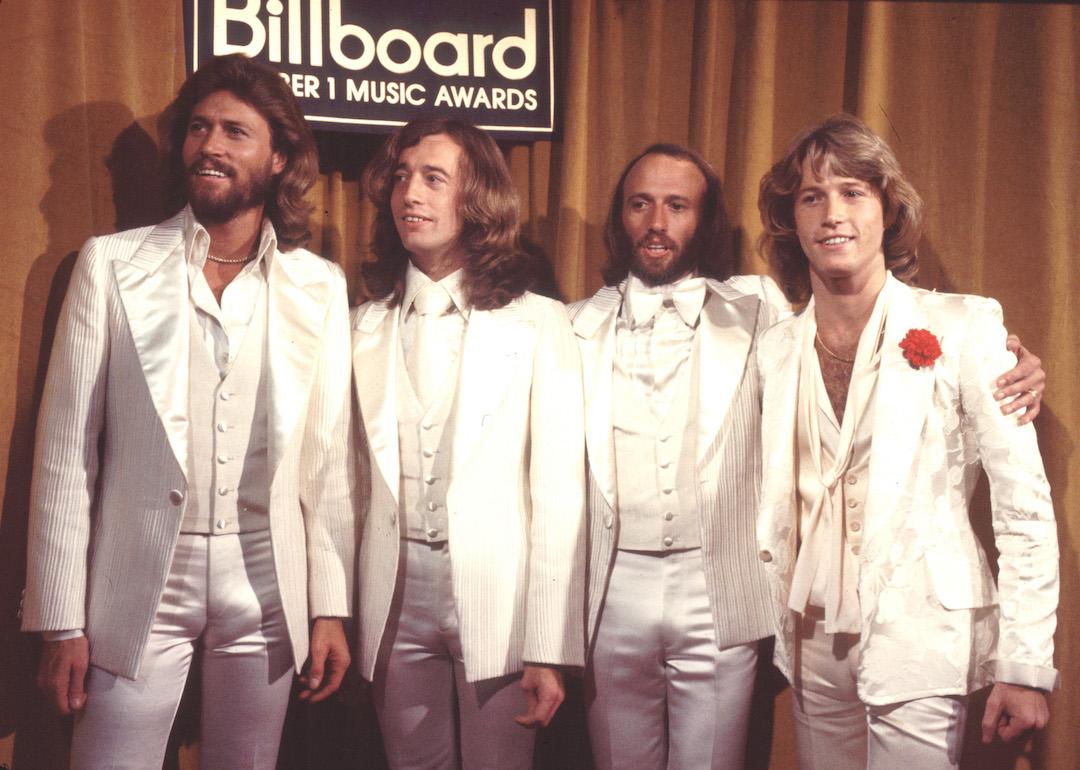  Barry Gibb, Robin Gibb, Maurice Gibb, and Andy Gibb in white suits at the 1977 Billboard Music Awards.