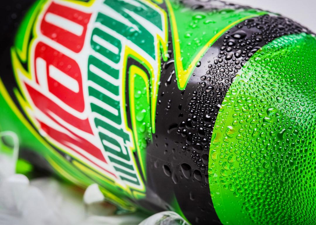 Two-liter bottle of Mountain Dew resting on ice.