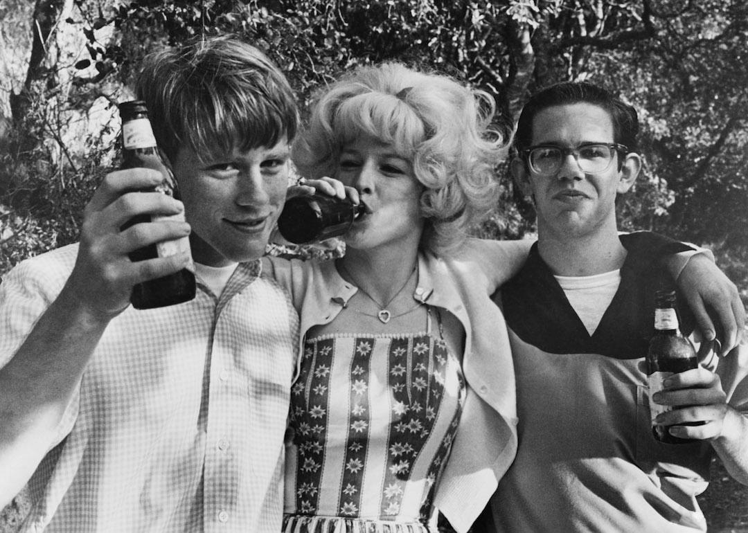 Actors Ron Howard as Steve, Candy Clark as Debbie, and Charles Martin Smith as Terry in the 1973 film 'American Graffiti.'