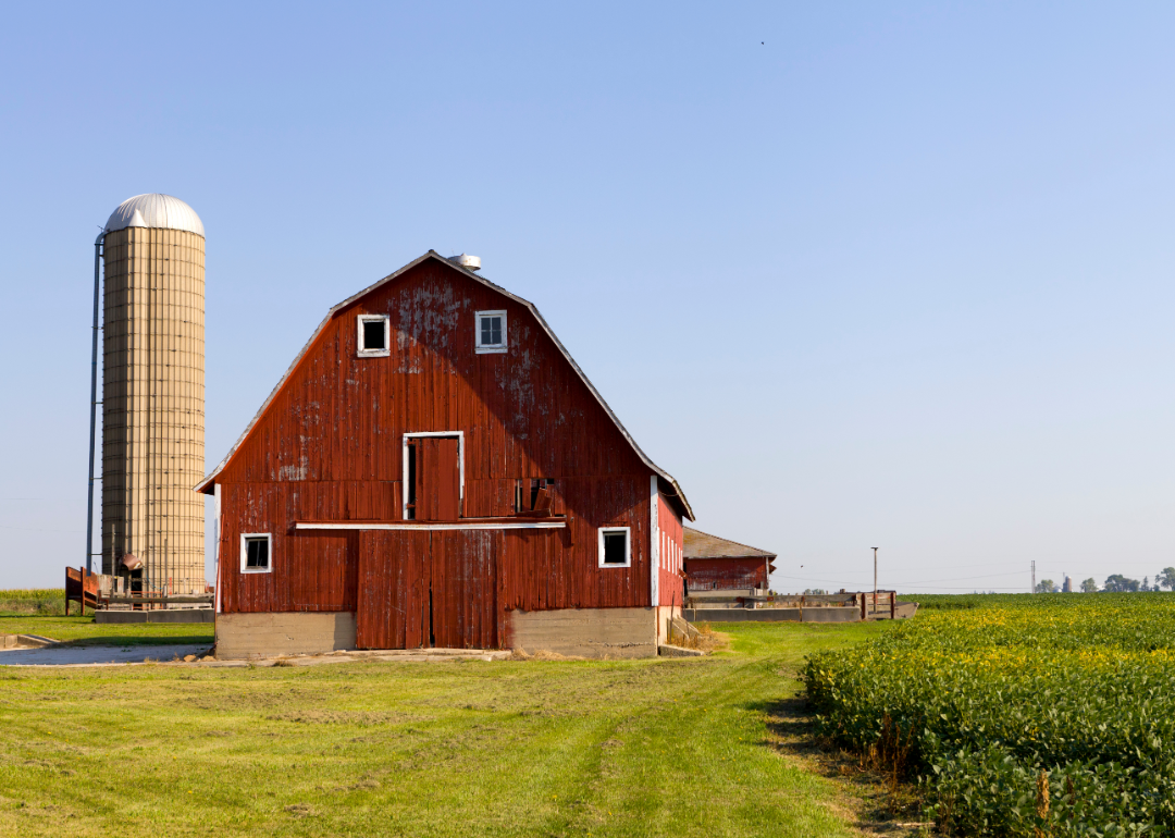 Red barn on green farmland in rural America.