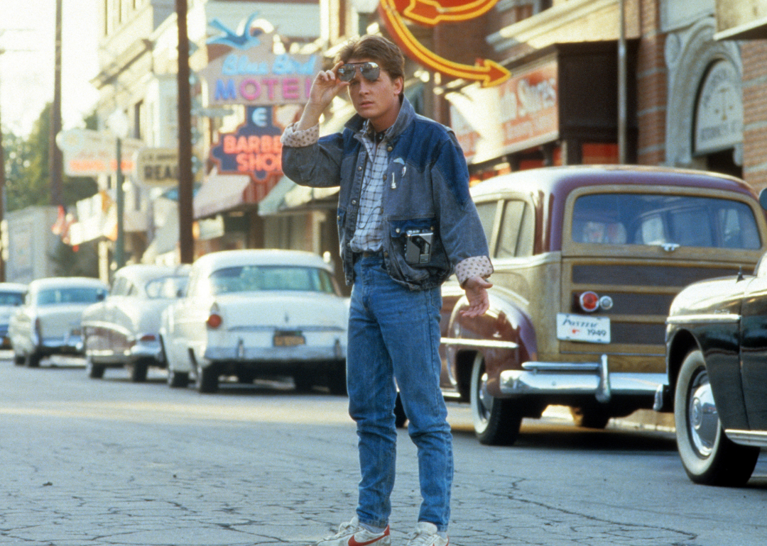 Michael J Fox walking across the street in a scene from the film "Back To The Future"