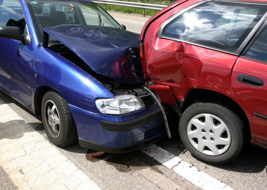A blue and a red car after a collision.