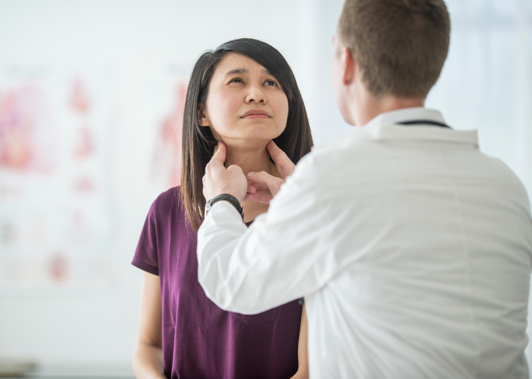 Patient gets throat examined in doctor's office.