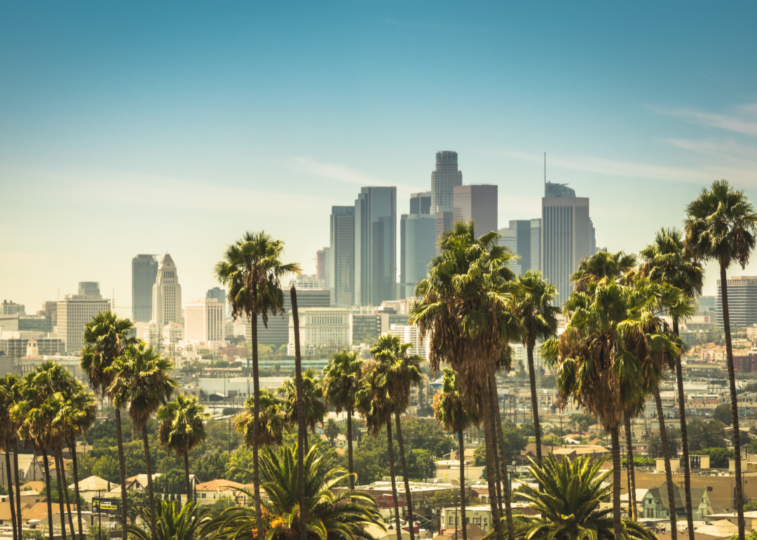 Downtown Los Angeles skyline looks hazy on a sunny day.