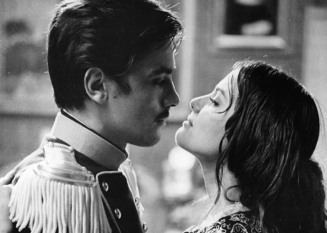 Actors Alain Delon and Claudia Cardinale embrace in a scene from the 1963 film 'The Leopard.'