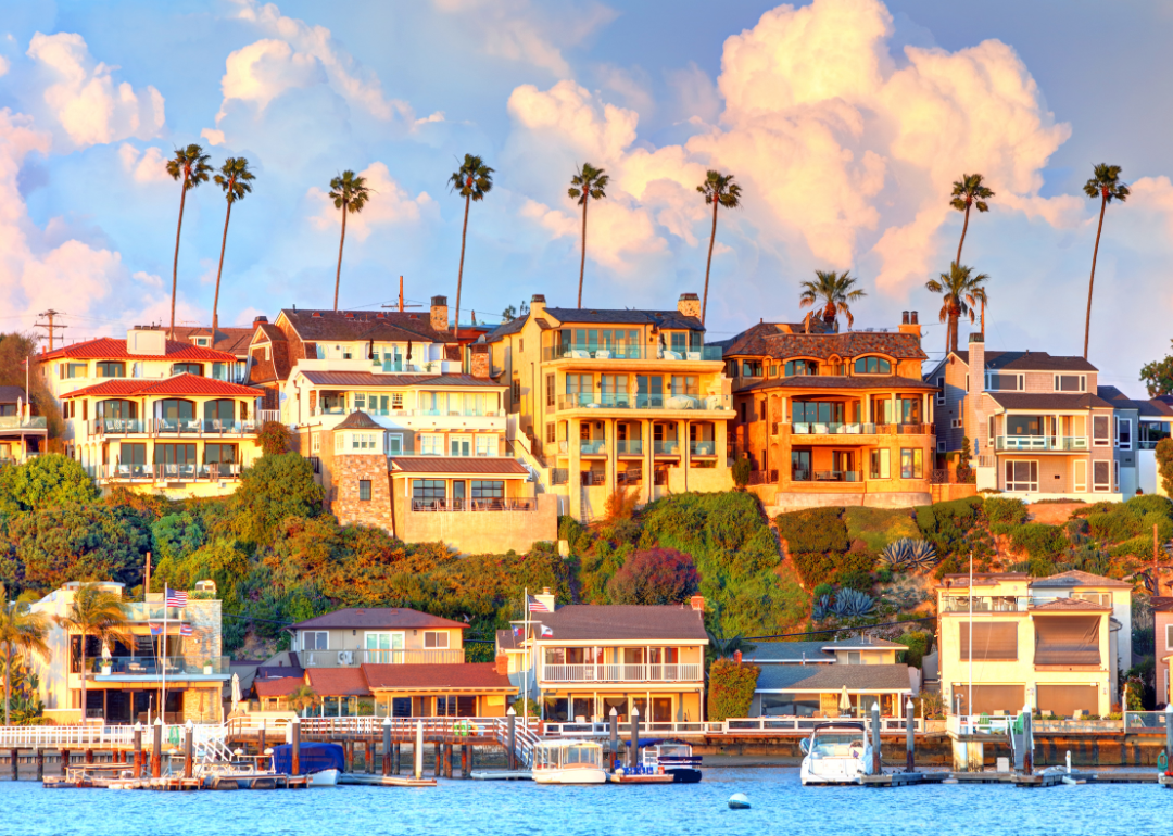 Houses on the water surrounded by palm trees in Newport Beach, California.