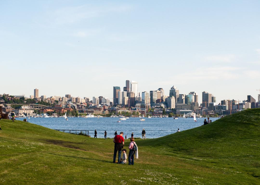 Families and friends gather at Gas Works Park in Seattle which overlooks Lake Union and the Seattle Skyline.