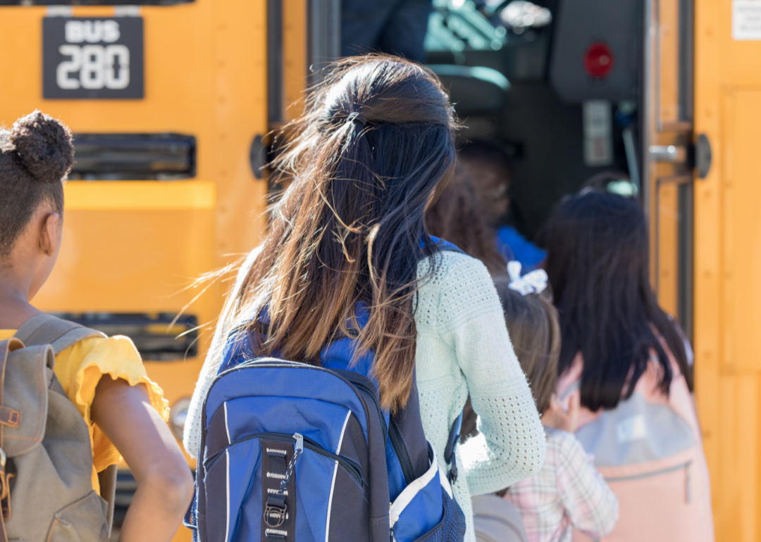 Students wait to board a school bus.