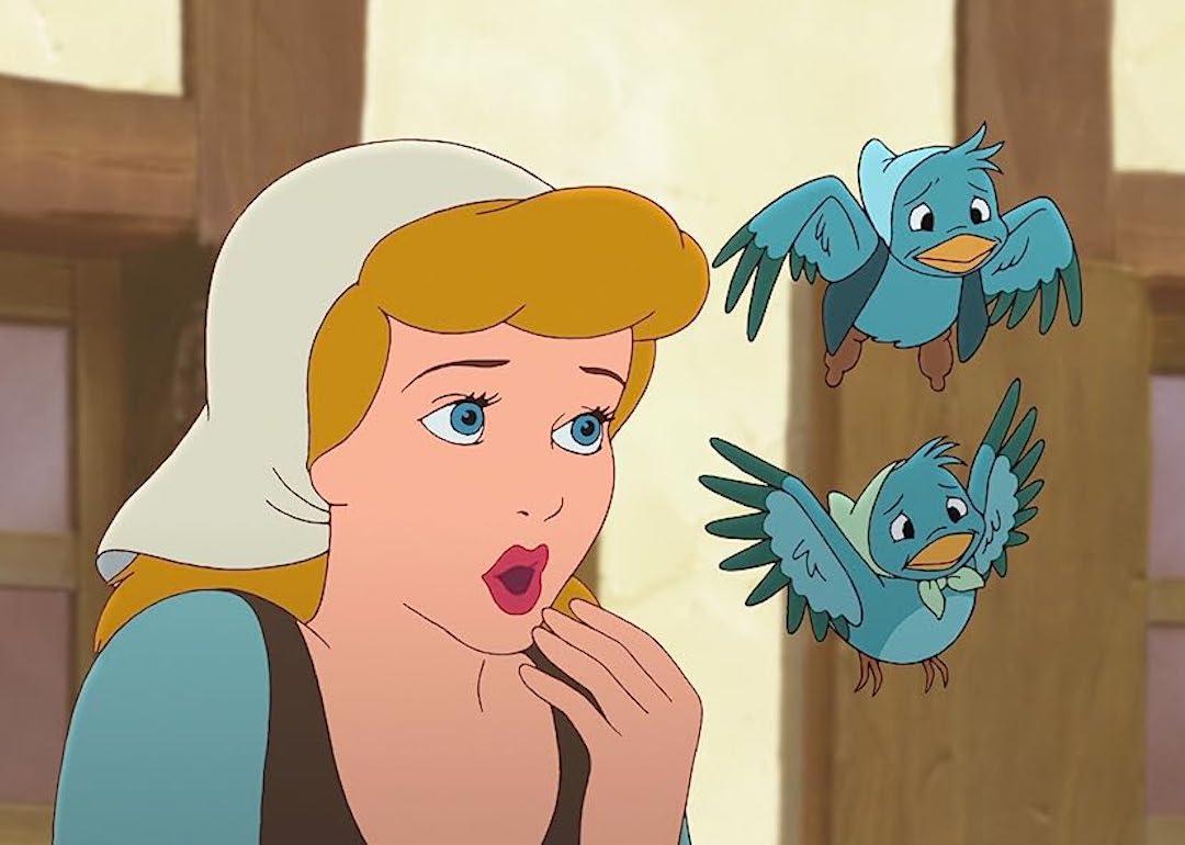 Cinderella in a white headscarf with two blue birds in 'Cinderella II: Dreams Come True.'