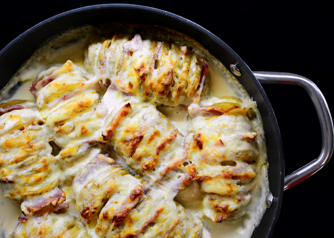 Croque monsieur hasselback potatoes in a cast iron skillet. 
