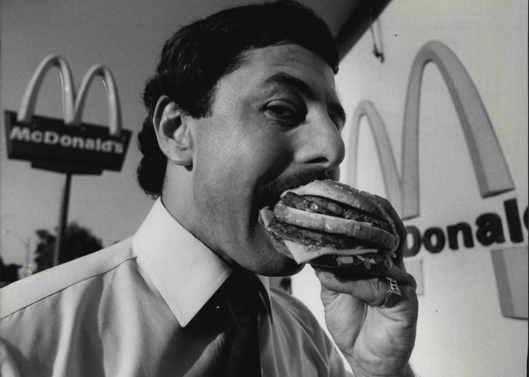 Cliff Young, national training manager for McDonald's, is seen eating a Big Mac.