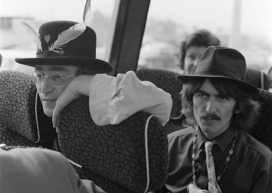 John Lennon and George Harrison, both of The Beatles, aboard their bus to film 'Magical Mystery Tour' on September 13, 1967, in Cornwall, United Kingdom.