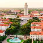 Aerial view of University of Texas (UT) Austin at sunset with the city of Austin in the background