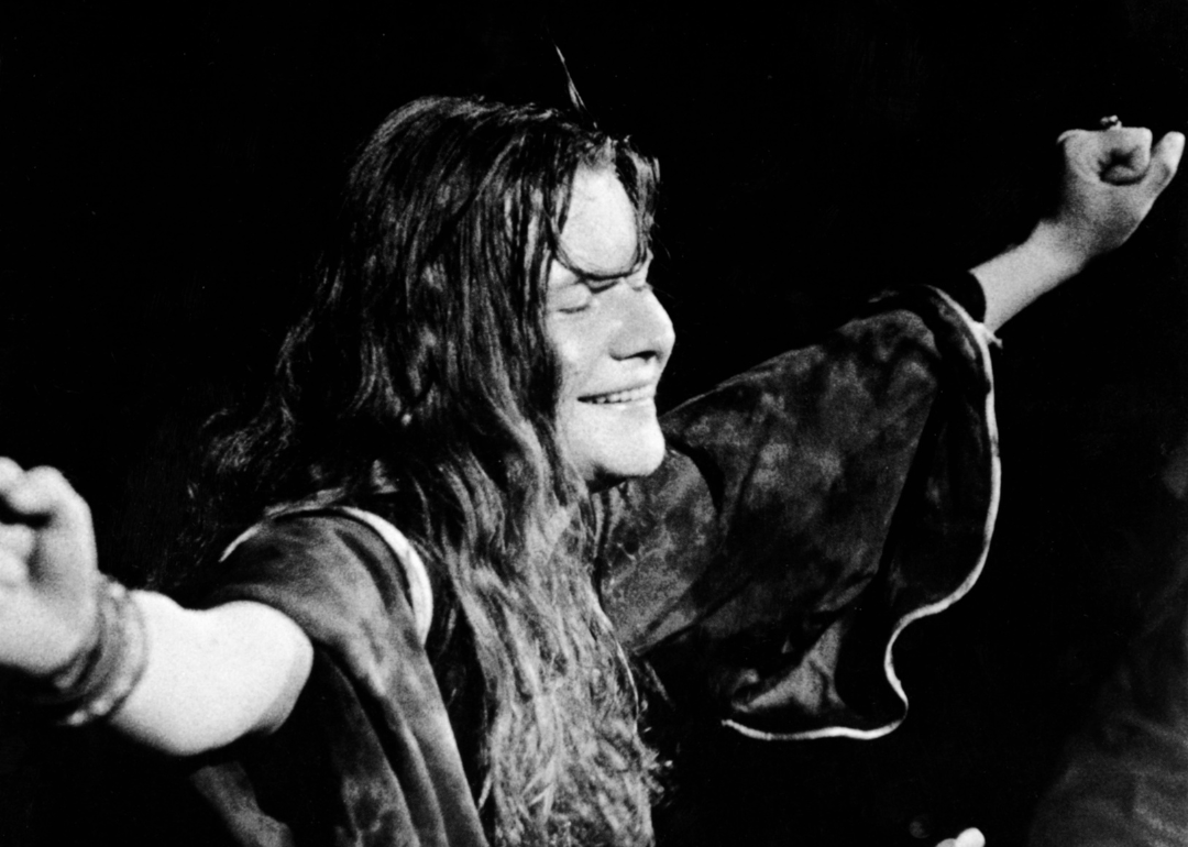 American singer Janis Joplin closes her eyes and outstretches her arms during a performance, late 1960s.
