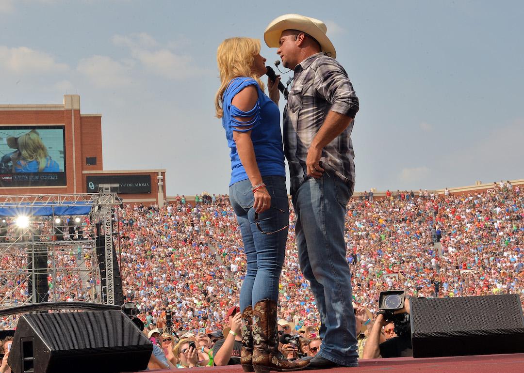 Trisha Yearwood and Garth Brooks perform during the Oklahoma Twister Relief Concert to benefit United Way of Central Oklahoma May Tornadoes Relief Fund at Gaylord Family Oklahoma Memorial Stadium on July 6, 2013 in Norman, Oklahoma.