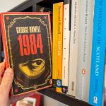 Pulling George Orwell's '1984' off of a bookshelf.