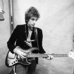 Bob Dylan plays a Fender Jazz bass with the harmonica around his neck while recording his album 'Bringing It All Back Home' on January 13-15, 1965 in Columbia's Studio A in New York City.
